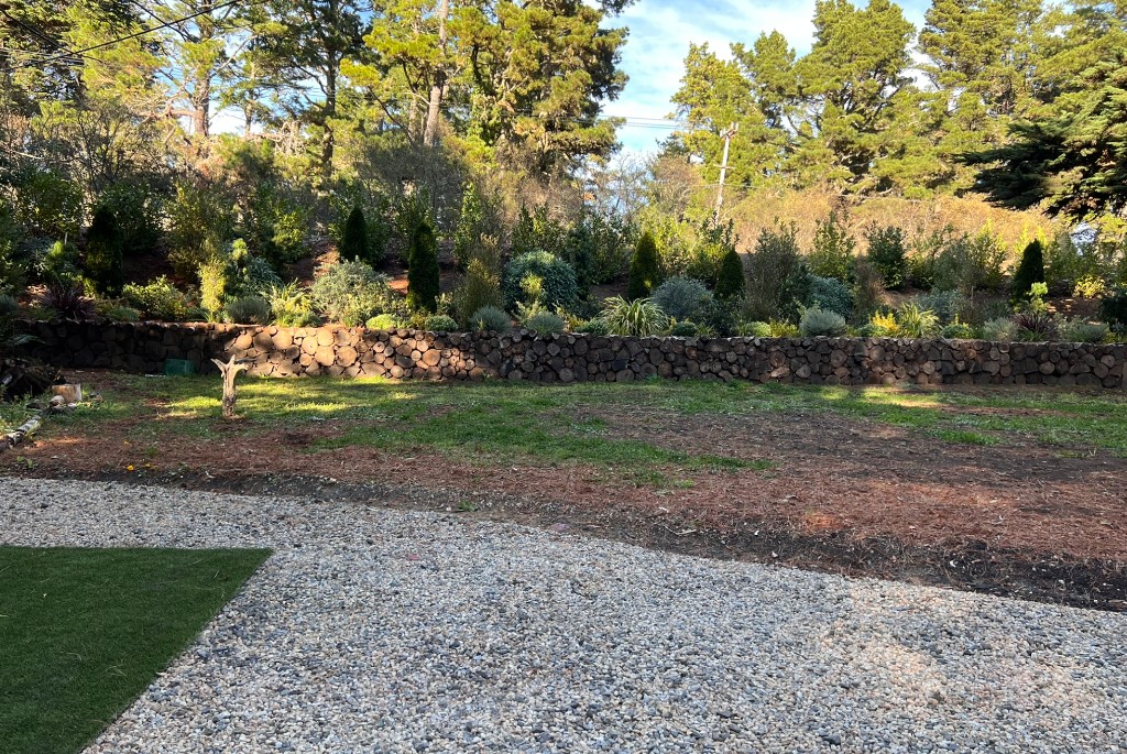Designed grounds with stone wall and mature landscaping